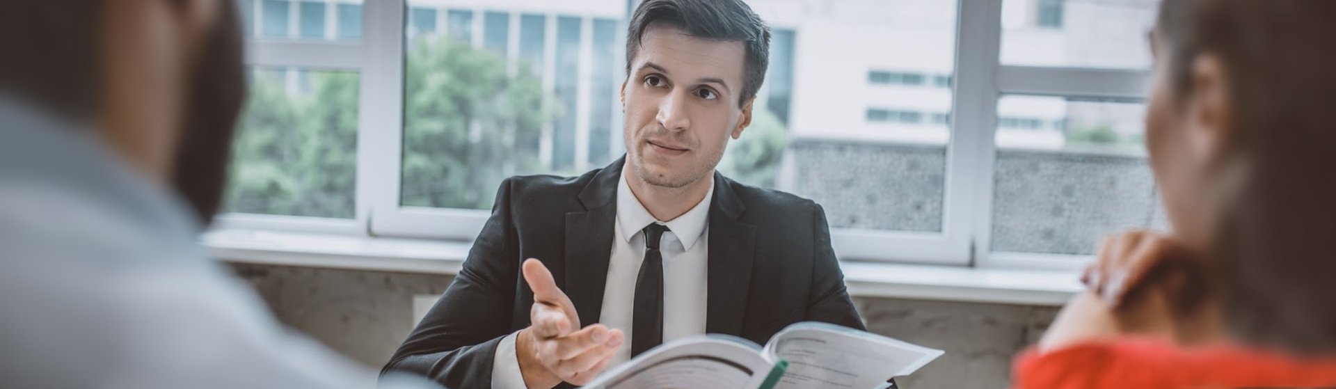 A mediator working with a landlord and tenant to resolve a real estate dispute with mediation